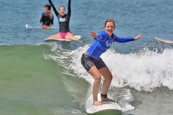 Woman Surfing and Cheering at our Costa Rica Surf Camp