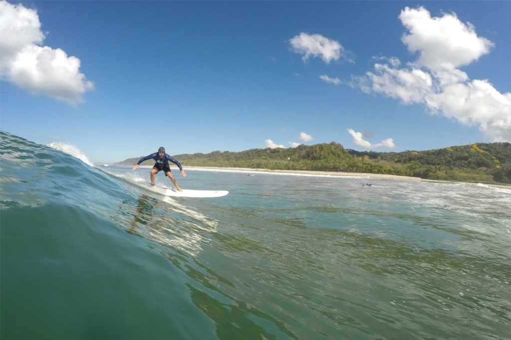 Man Surfing During His Costa Rica Surf Vacation