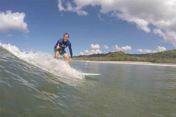 Man Surfing at Pura Vida Costa Rica Surf Camp