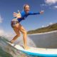 Woman Surfing At Surf and Yoga Retreat