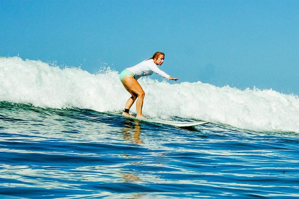 Woman Surfing at Pura Vida Surf Camp Costa Rica