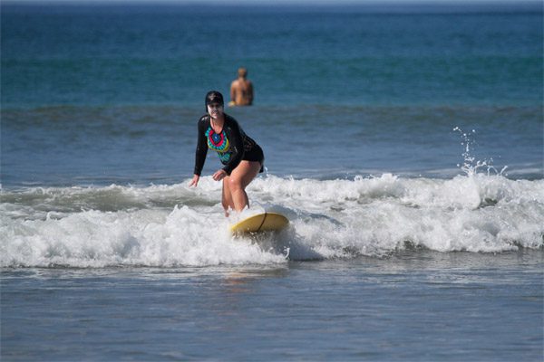 Woman With Suncreen Surfing in Costa Rica
