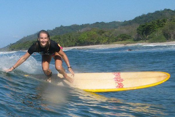 Woman Smiling and Surfing during her Costa Rica Beach Vacation