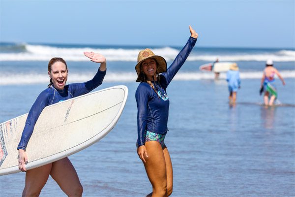 Women Waving and Surfing in Costa Rica