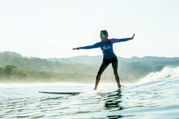 Woman with Suncreen Surfing in Costa Rica