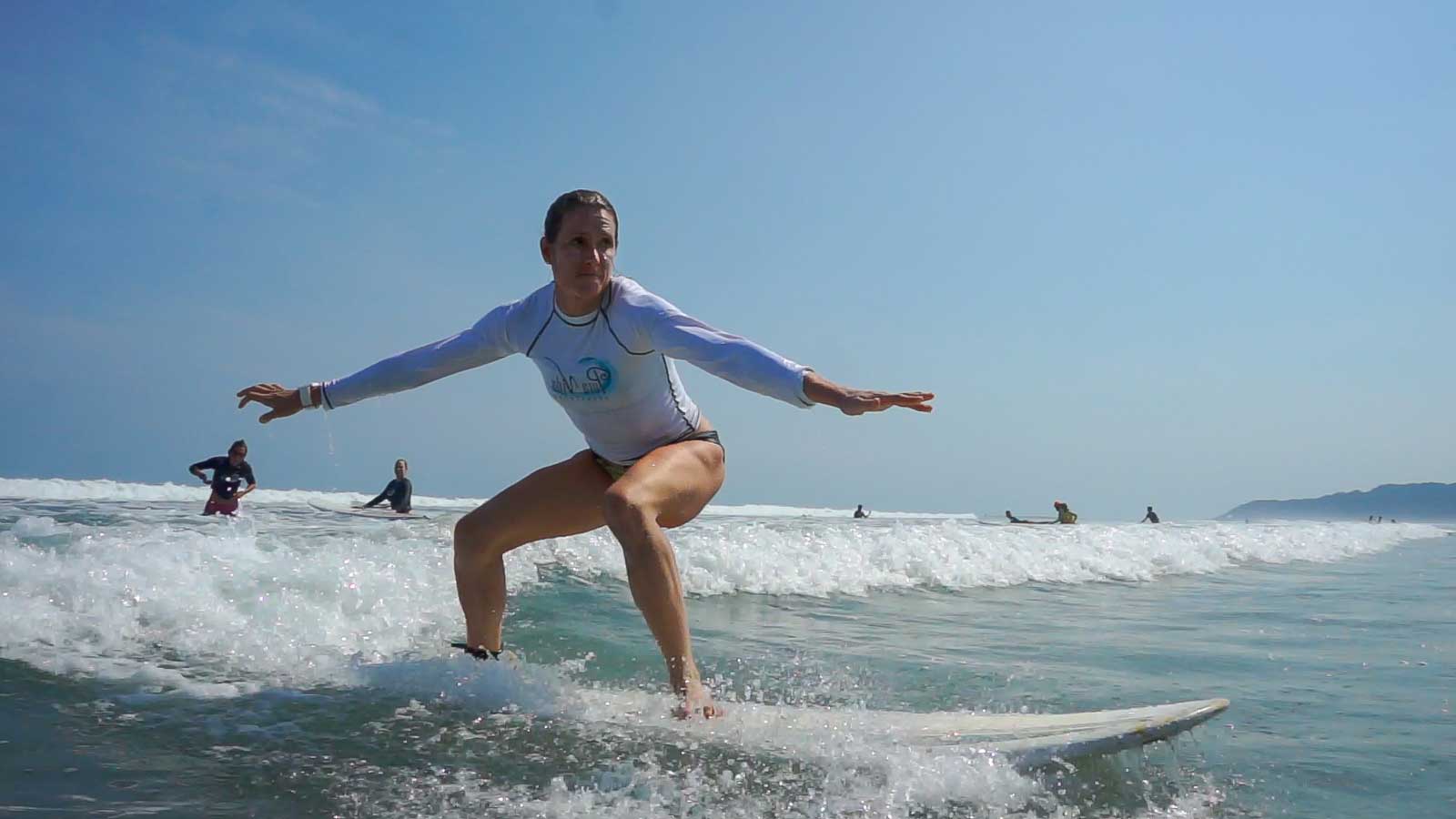 Woman Surfing during her Costa Rican Surf Camp Vacation