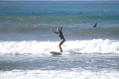 Woman 50+ surfing in Costa Rica Pura Vida Adventures