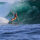 Woman surfing a large wave.