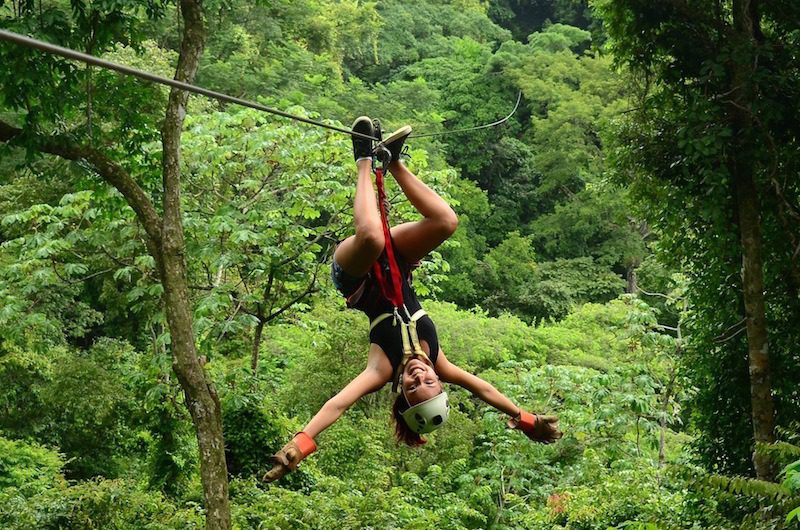 A person upside down on a zip line in Santa Teresa, Costa Rica.