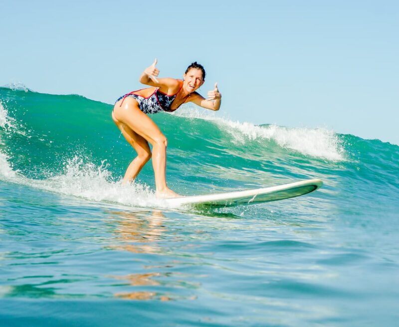 Happy female surfer on a pretty wave in Santa Teresa, Costa Rica.