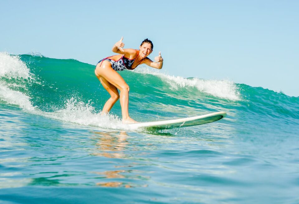 Happy female surfer on a pretty wave in Santa Teresa, Costa Rica.