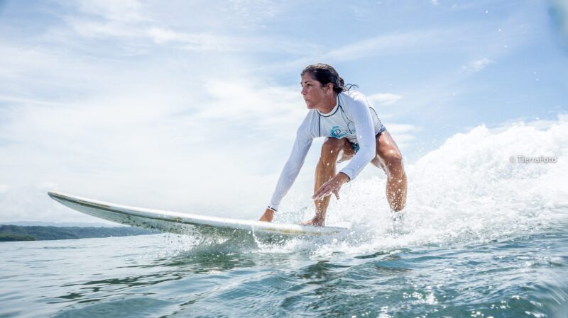 Female surfer on a longboard in Santa Teresa, Costa Rica.