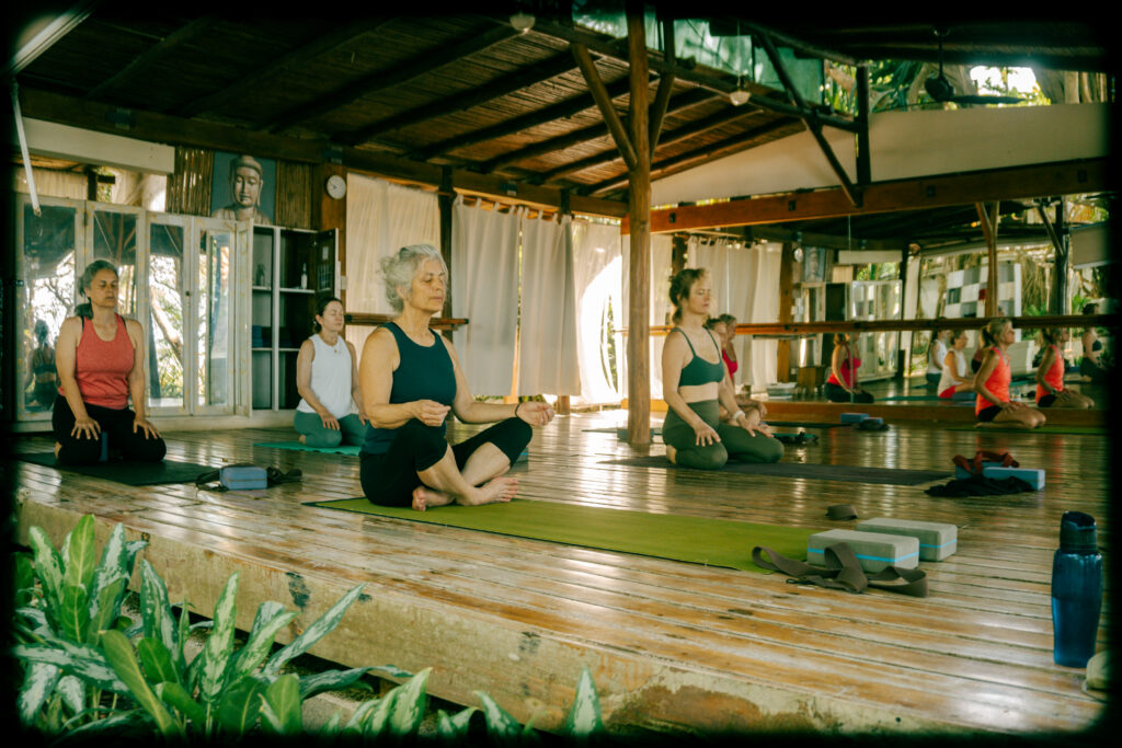 Women in a morning yoga class at Pura Vida Adventures surf and yoga retreat in Santa Teresa, Costa Rica