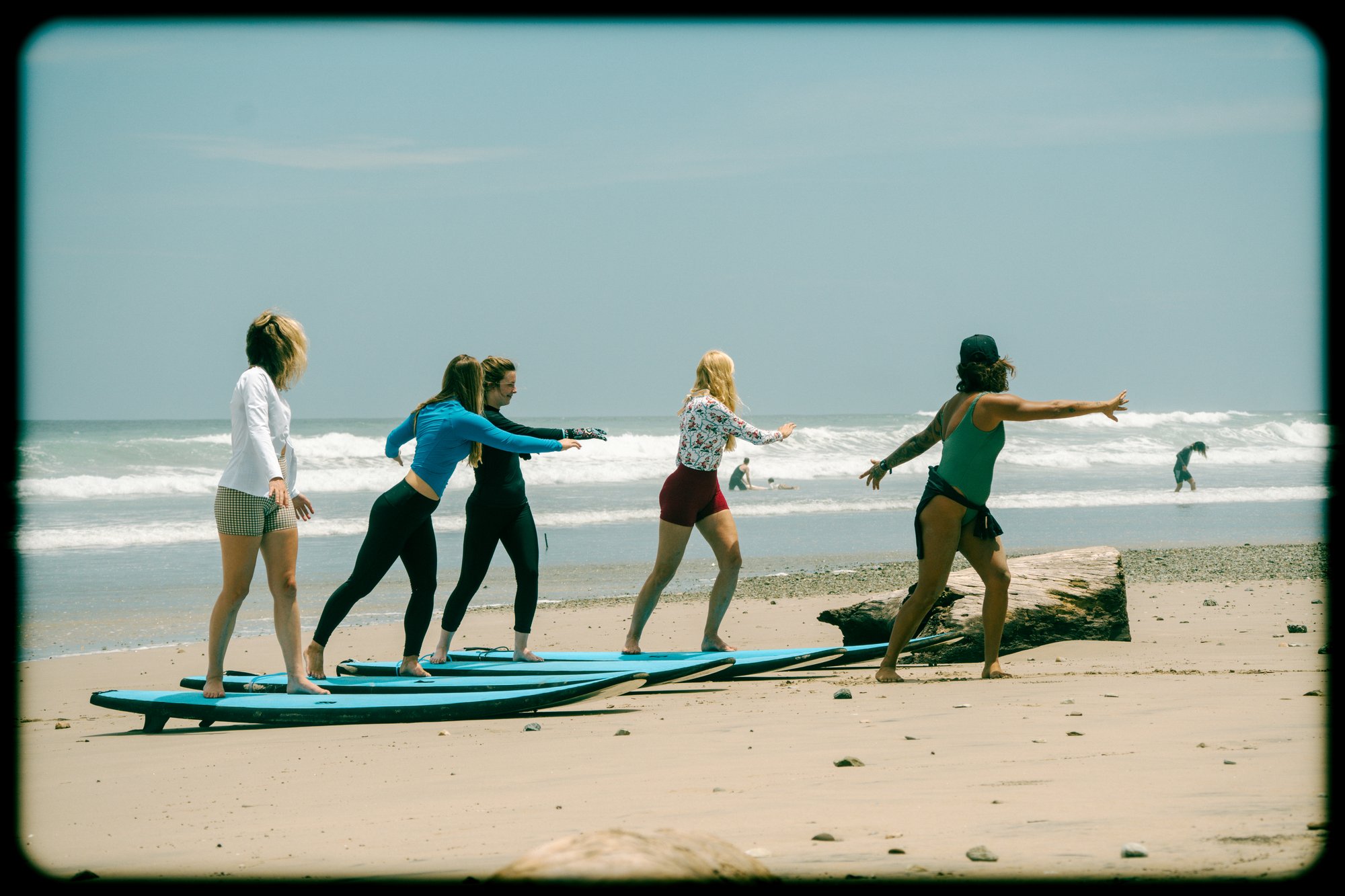 Surf instructor teaching pop up technique on the sand in Santa Teresa, Costa Rica